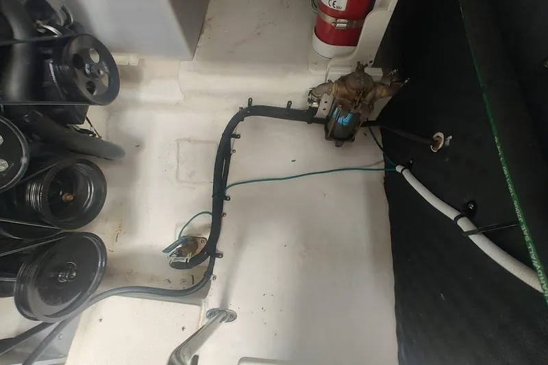 Slide: The Image of Engine compartment of a 2021 Chaparral 347 SSX boat, featuring mechanical components. - 24