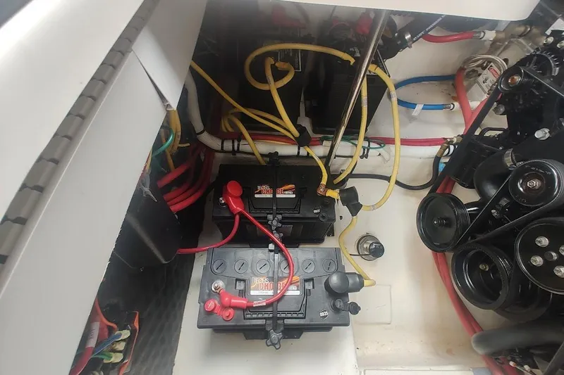 Slide: The Image of Engine compartment of a 2021 Chaparral 347 SSX boat, showing batteries and wiring. - 25