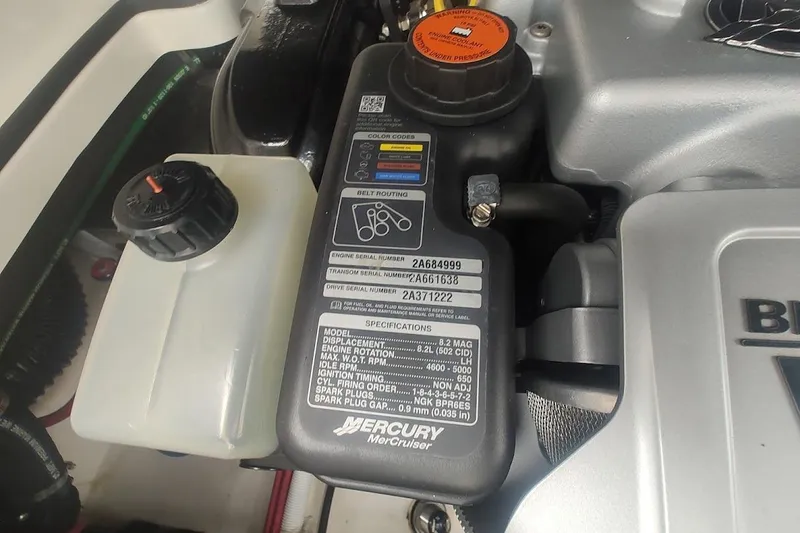 Slide: The Image of Engine compartment of a 2021 Chaparral 347 SSX boat, featuring Mercury MerCruiser components. - 27