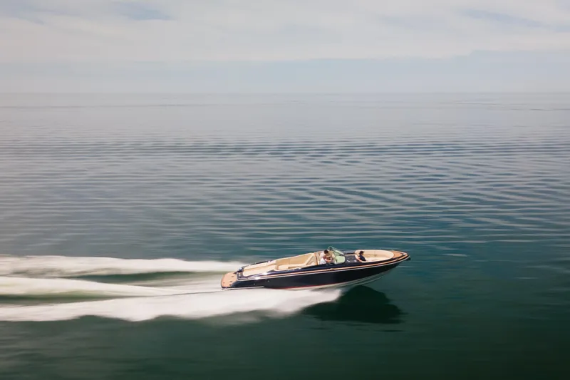 Slide: The Image of 2022 Chris Craft 34 Launch Heritage cruising on calm water. - 10