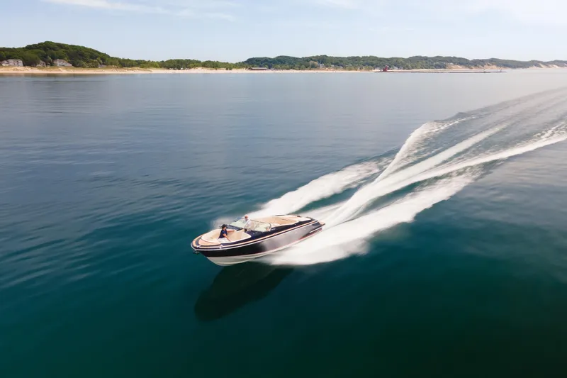 Slide: The Image of 2022 Chris Craft 34 Launch Heritage cruising on calm waters, leaving a wake trail. - 12