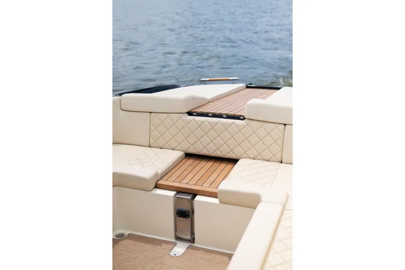 Slide: The Image of Luxurious interior of 2022 Chris Craft 34 Launch Heritage boat with quilted seating and wooden accents. - 17