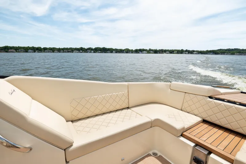 Slide: The Image of Luxurious seating on 2022 Chris Craft 34 Launch Heritage boat, cruising on a serene lake. - 18