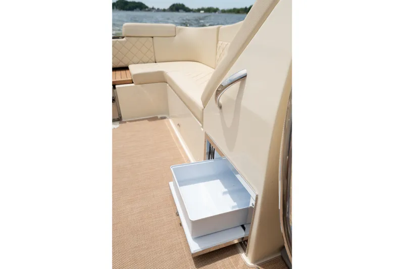 Slide: The Image of 2022 Chris Craft 34 Launch Heritage boat interior with open storage drawer. - 21