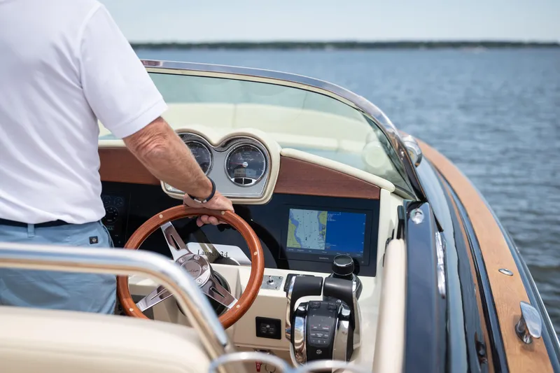 Slide: The Image of 2022 Chris Craft 34 Launch Heritage boat dashboard with GPS on open water. - 25