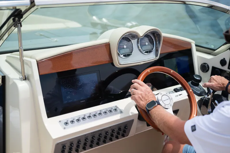 Slide: The Image of 2022 Chris Craft 34 Launch Heritage dashboard with wooden steering wheel and modern controls. - 26