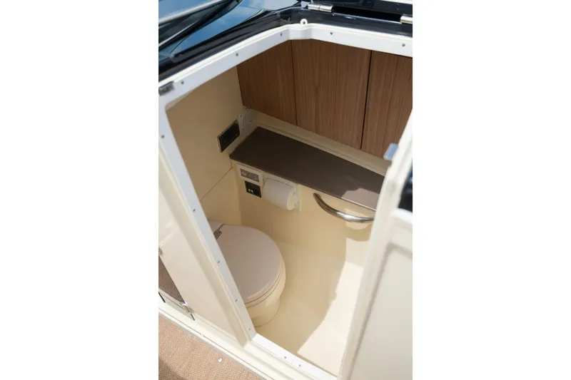 Slide: The Image of Interior of 2022 Chris Craft 34 Launch Heritage boat bathroom with wooden cabinetry. - 29
