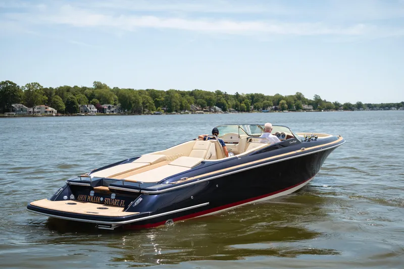 Slide: The Image of 2022 Chris Craft 34 Launch Heritage boat cruising on a serene lake. - 3