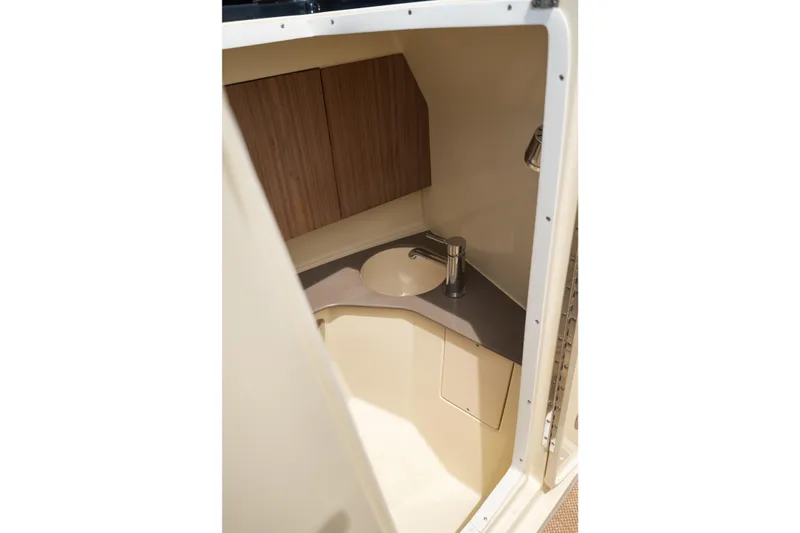 Slide: The Image of 2022 Chris Craft 34 Launch Heritage boat interior with compact sink and wooden cabinetry. - 30