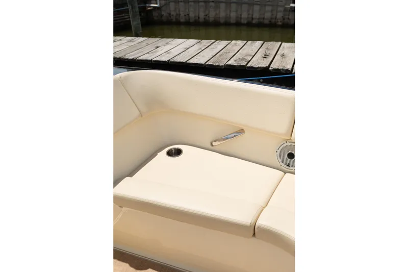 Slide: The Image of Luxurious seating on 2022 Chris Craft 34 Launch Heritage boat, featuring cup holder and speaker. - 34