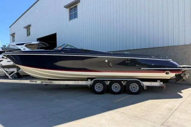 Slide: The Image of 2022 Chris Craft 34 Launch Heritage boat on a trailer outside a warehouse. - 38