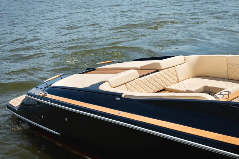Slide: The Image of 2022 Chris Craft 34 Launch Heritage boat with elegant seating on water. - 4