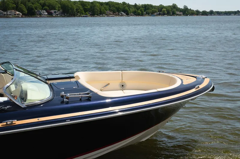 Slide: The Image of 2022 Chris Craft 34 Launch Heritage boat on a serene lake. - 5
