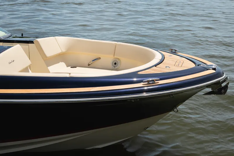 Slide: The Image of 2022 Chris Craft 34 Launch Heritage boat with elegant wood detailing on water. - 6