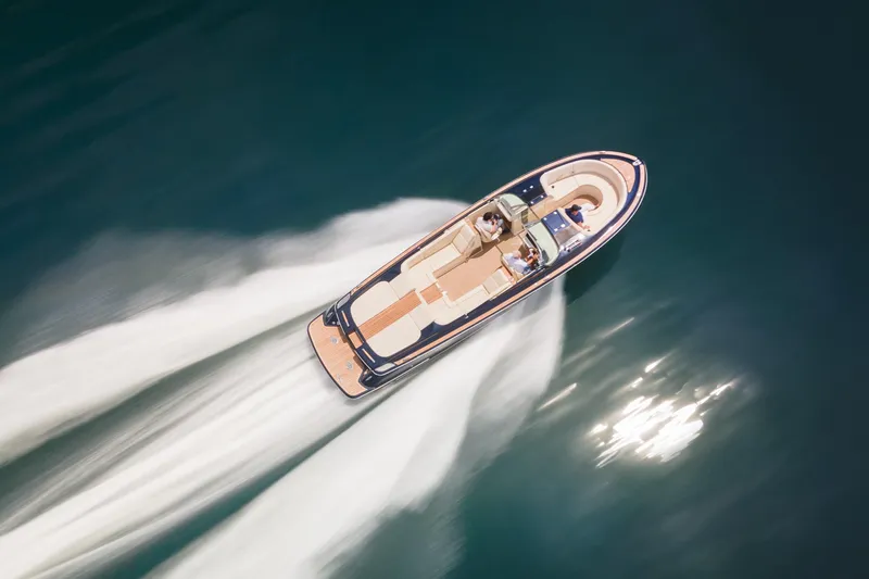 Slide: The Image of 2022 Chris Craft 34 Launch Heritage cruising on open water, aerial view. - 8