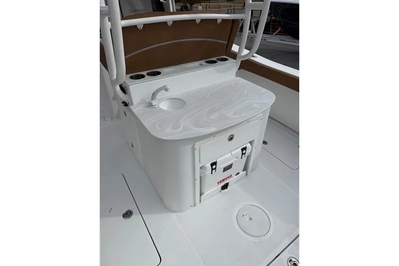 Slide: The Image of 2026 Sea Hunt Ultra 305 Coffin Box boat with tan seating and dual engines. - 10