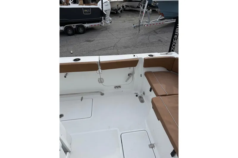 Slide: The Image of 2026 Sea Hunt Ultra 305 Coffin Box boat interior with sink and storage. - 11