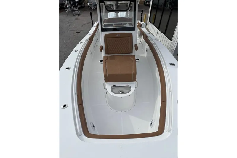 Slide: The Image of 2026 Sea Hunt Ultra 305 Coffin Box boat on trailer, rear view, parked outdoors. - 3