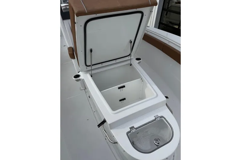 Slide: The Image of 2026 Sea Hunt Ultra 305 Coffin Box boat with tan seating and spacious deck. - 4