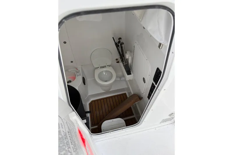 Slide: The Image of 2026 Sea Hunt Ultra 305 Coffin Box with open storage compartment on deck. - 5
