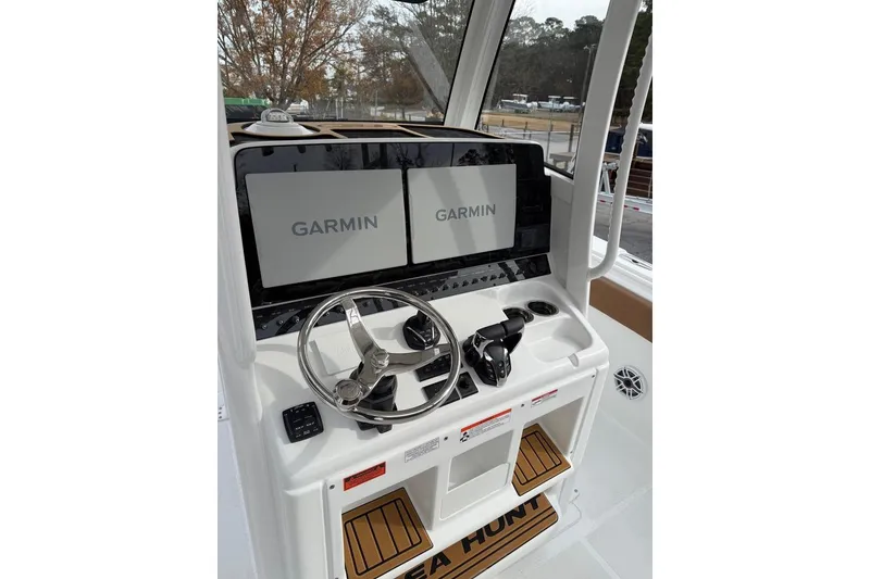 Slide: The Image of Interior of 2026 Sea Hunt Ultra 305 Coffin Box boat, featuring compact marine toilet. - 6