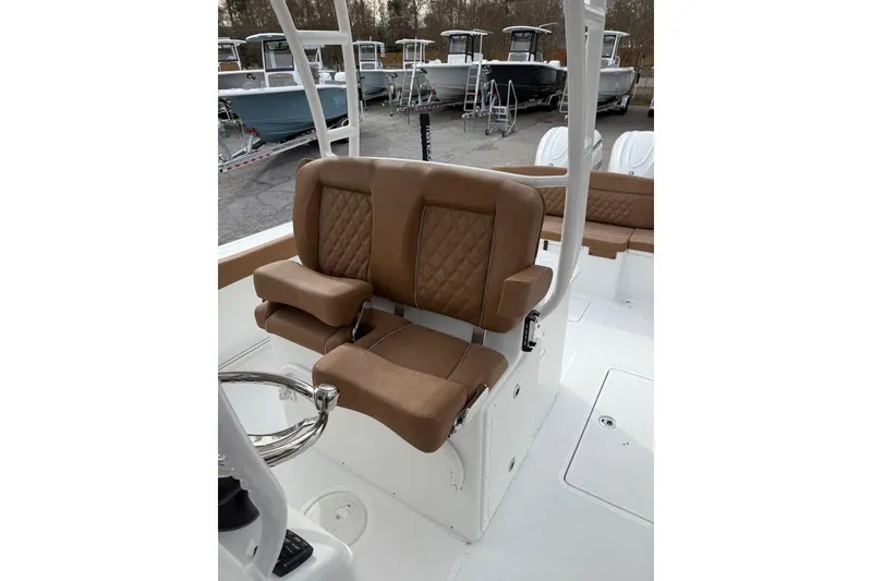 Slide: The Image of 2026 Sea Hunt Ultra 305 Coffin Box boat helm with Garmin electronics and white T-top. - 8