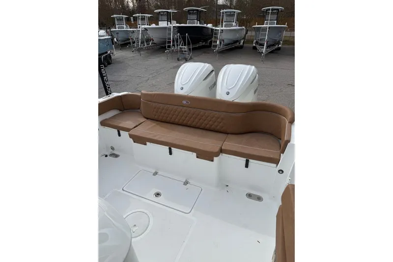 Slide: The Image of 2026 Sea Hunt Ultra 305 Coffin Box boat with tan leather seating and steering wheel. - 9