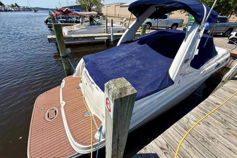 Slide: The Image of 2005 Sea Ray Sundancer 260 docked at marina with blue cover. - 11