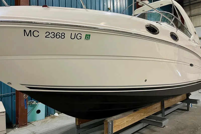Slide: The Image of 2005 Sea Ray Sundancer 260 boat in storage, displaying registration number MC 2368 UG. - 12