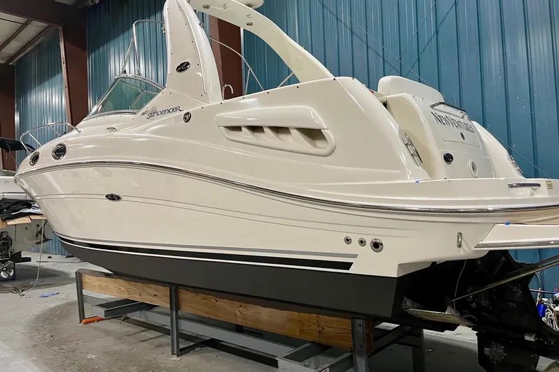 Slide: The Image of 2005 Sea Ray Sundancer 260 boat in a storage facility, side view. - 13