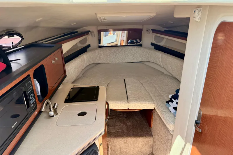 Slide: The Image of Interior of 2005 Sea Ray Sundancer 260 with cozy cabin and kitchenette. - 18