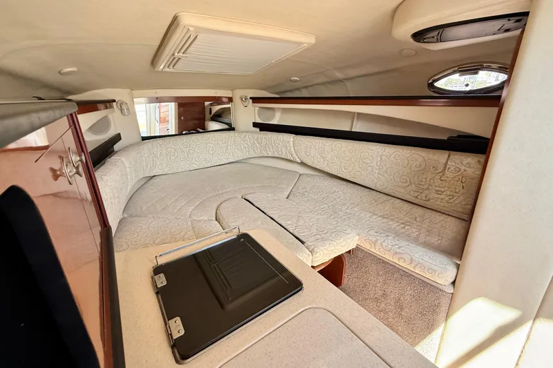 Slide: The Image of Interior cabin of 2005 Sea Ray Sundancer 260 with plush seating and elegant design. - 20
