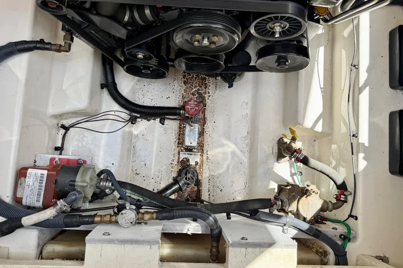 Slide: The Image of Engine compartment of a 2005 Sea Ray Sundancer 260 boat, showing belts and hoses. - 27
