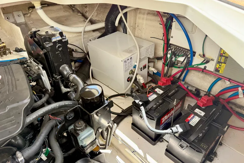 Slide: The Image of Engine compartment of a 2005 Sea Ray Sundancer 260 with batteries and wiring. - 28