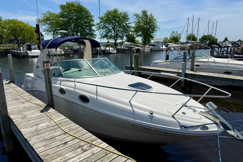 Slide: The Image of 2005 Sea Ray Sundancer 260 docked at a marina with clear skies. - 3