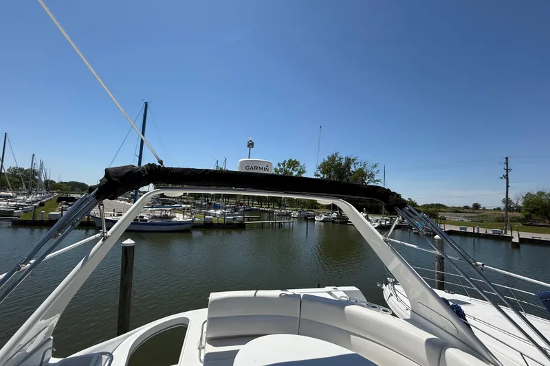 Slide: The Image of 1999 Carver 450 Voyager Pilothouse yacht docked in a marina under clear blue skies. - 11
