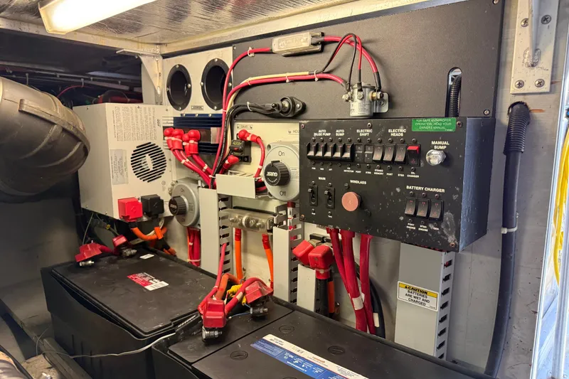 Slide: The Image of Electrical panel and battery setup in a 1999 Carver 450 Voyager Pilothouse boat. - 19