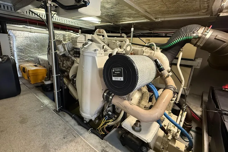 Slide: The Image of Engine room of a 1999 Carver 450 Voyager Pilothouse yacht, showcasing machinery and components. - 20