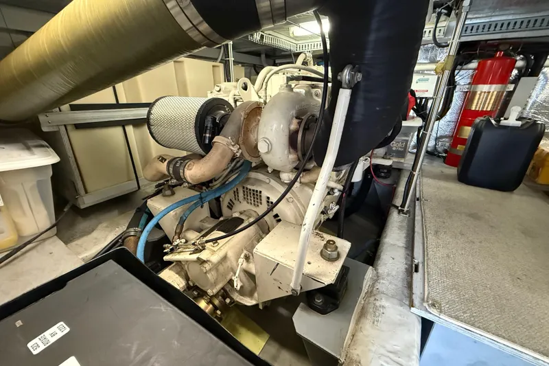 Slide: The Image of Engine room of a 1999 Carver 450 Voyager Pilothouse with visible components and equipment. - 21