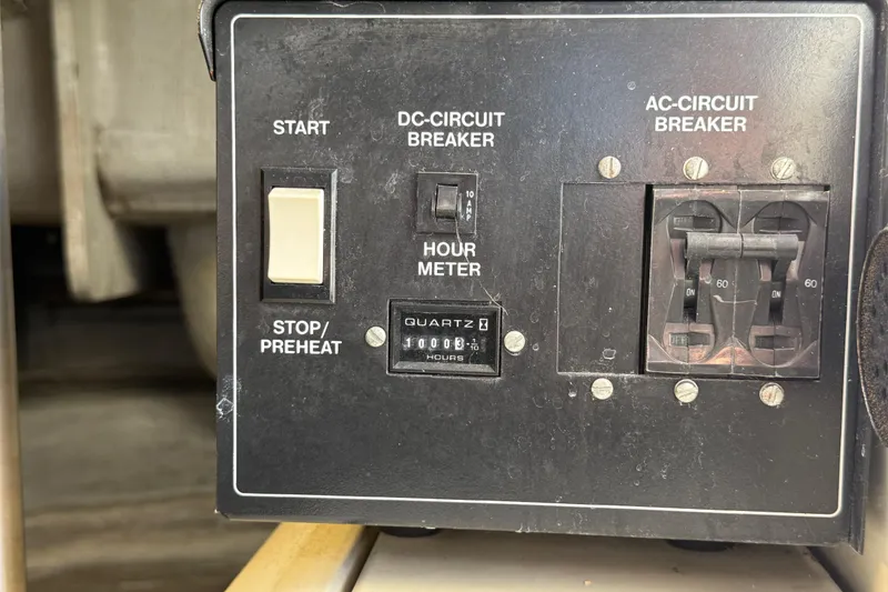 Slide: The Image of Control panel of a 1999 Carver 450 Voyager Pilothouse with circuit breakers and hour meter. - 23