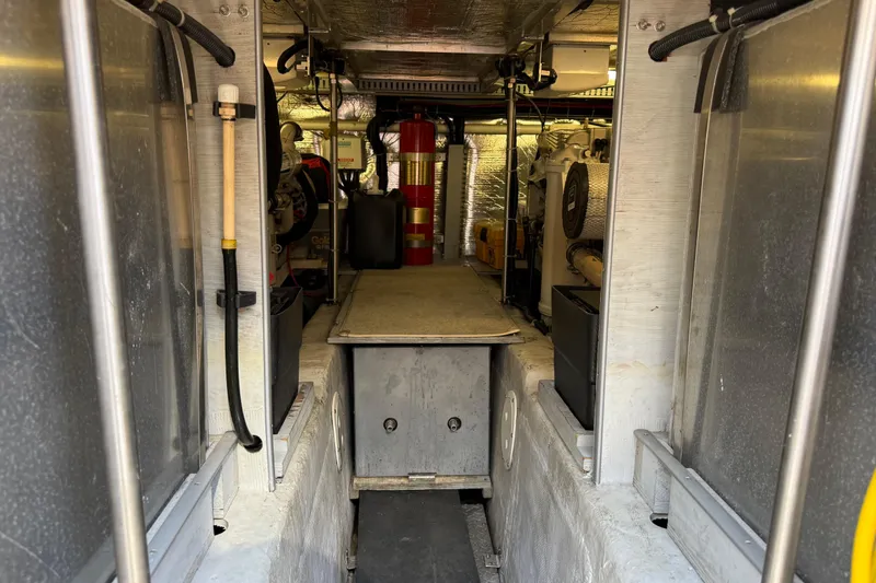 Slide: The Image of Engine room of 1999 Carver 450 Voyager Pilothouse with visible equipment and fire extinguisher. - 24