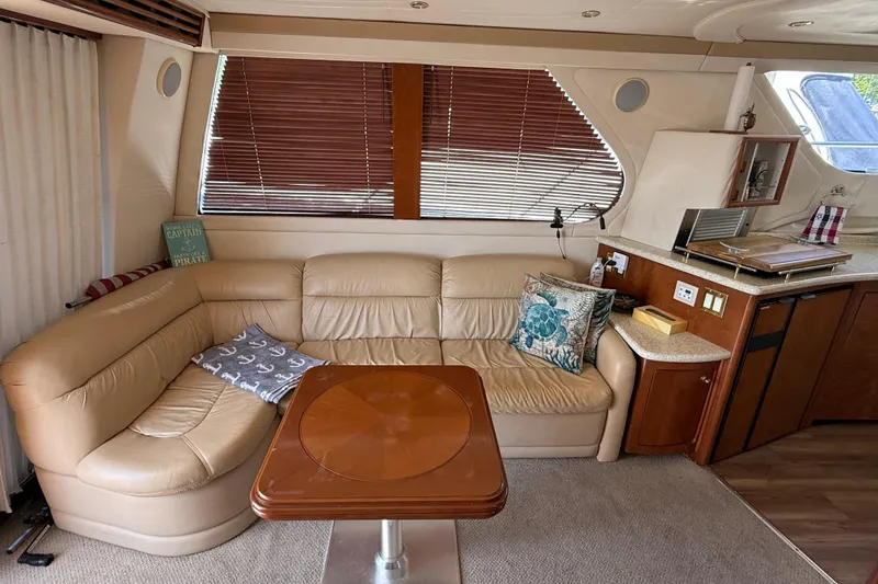Slide: The Image of Luxurious interior of a 1999 Carver 450 Voyager Pilothouse with leather seating and wooden accents. - 26