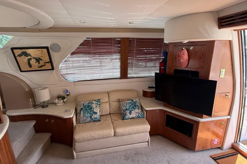 Slide: The Image of Interior of 1999 Carver 450 Voyager Pilothouse with cozy seating and nautical decor. - 27