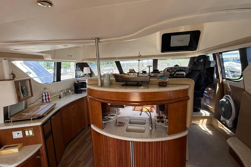 Slide: The Image of Interior of 1999 Carver 450 Voyager Pilothouse with modern kitchen and helm station. - 28
