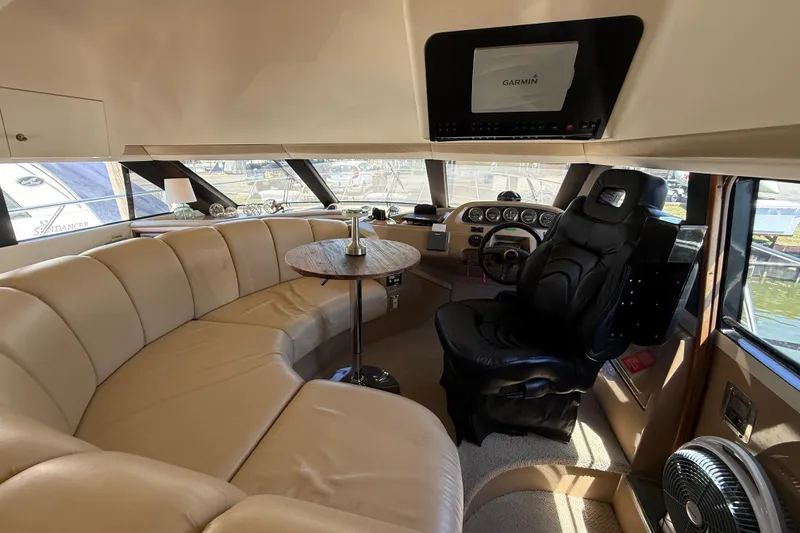 Slide: The Image of Luxurious interior of a 1999 Carver 450 Voyager Pilothouse with leather seating and helm. - 29