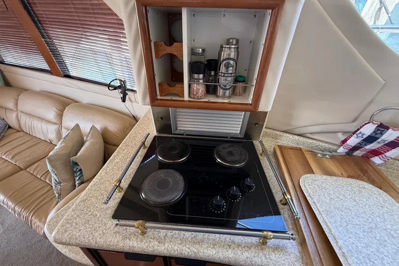 Slide: The Image of Compact kitchen area in a 1999 Carver 450 Voyager Pilothouse yacht with stove and storage. - 33