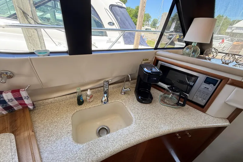 Slide: The Image of Interior of 1999 Carver 450 Voyager Pilothouse with sink, coffee maker, and microwave. - 34