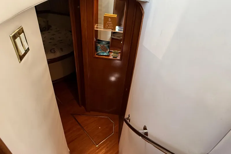 Slide: The Image of Interior view of 1999 Carver 450 Voyager Pilothouse, featuring wooden flooring and cabin entrance. - 35