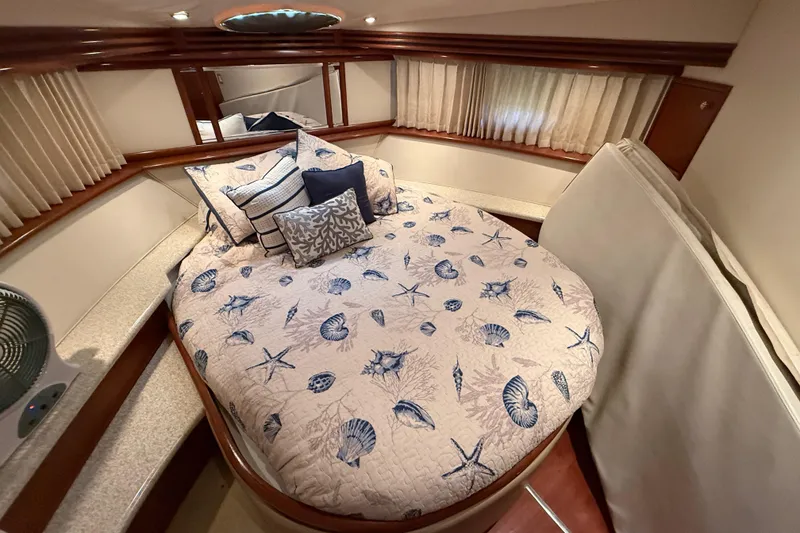 Slide: The Image of Luxurious 1999 Carver 450 Voyager Pilothouse bedroom with nautical-themed bedding. - 38