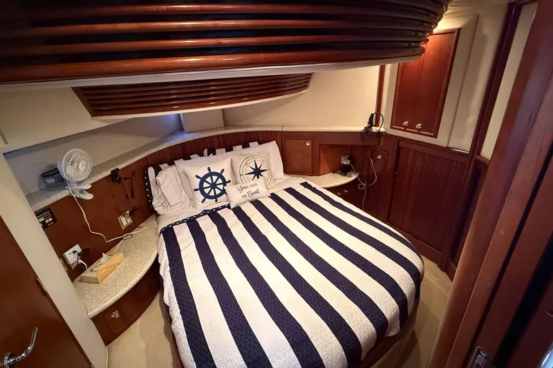 Slide: The Image of Bedroom interior of 1999 Carver 450 Voyager Pilothouse with nautical-themed bedding. - 45
